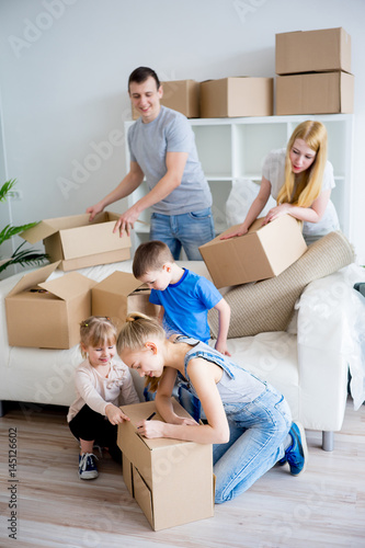 Family unpacking boxes © Nichizhenova Elena