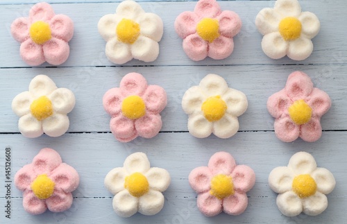 Canvas Print Pink, white and yellow daisy marshmallow sweets on duck egg blue painted table