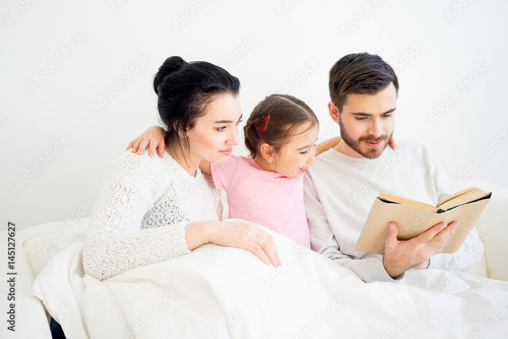 Family reading a book Family reading a book
