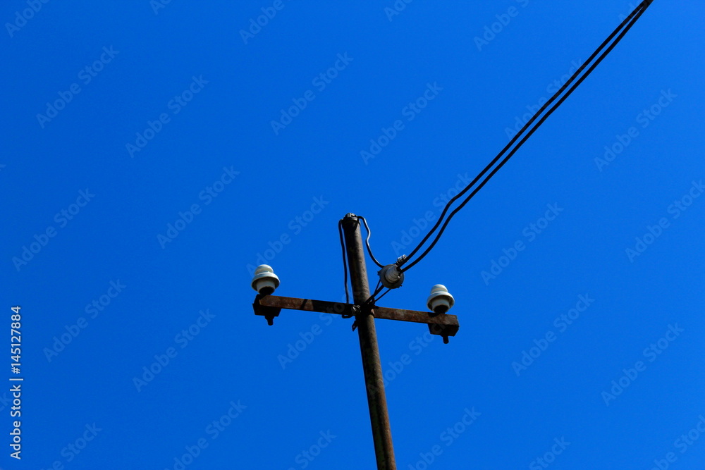 Electric pole and wire against blue sky Electric pole and wire against blue sky