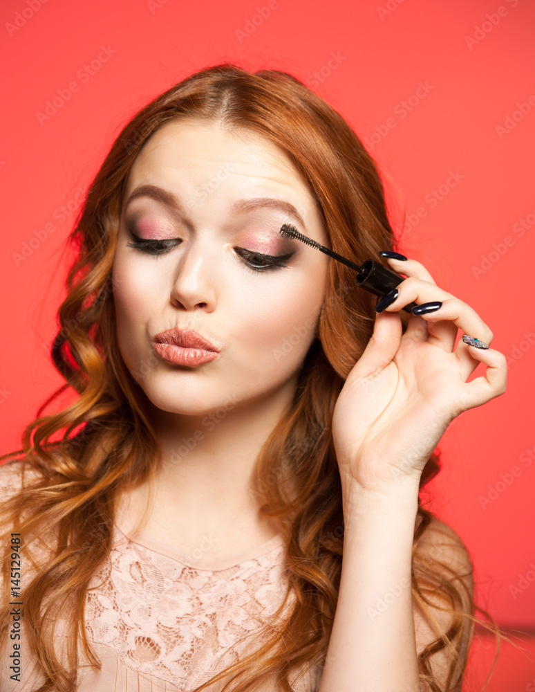 Young woman applying make up Young woman applying make up