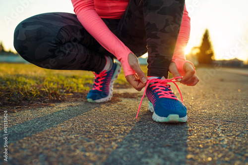 Running shoes - woman tying shoe laces