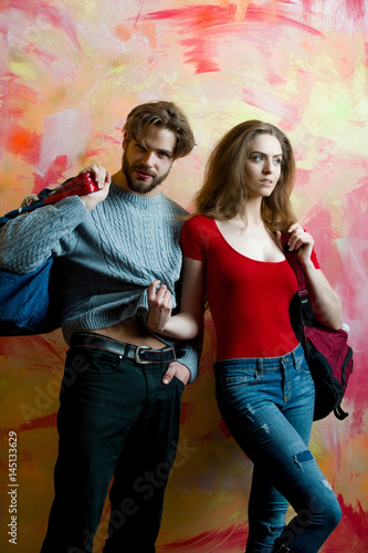 Pretty girl with backpack and bearded man with bag