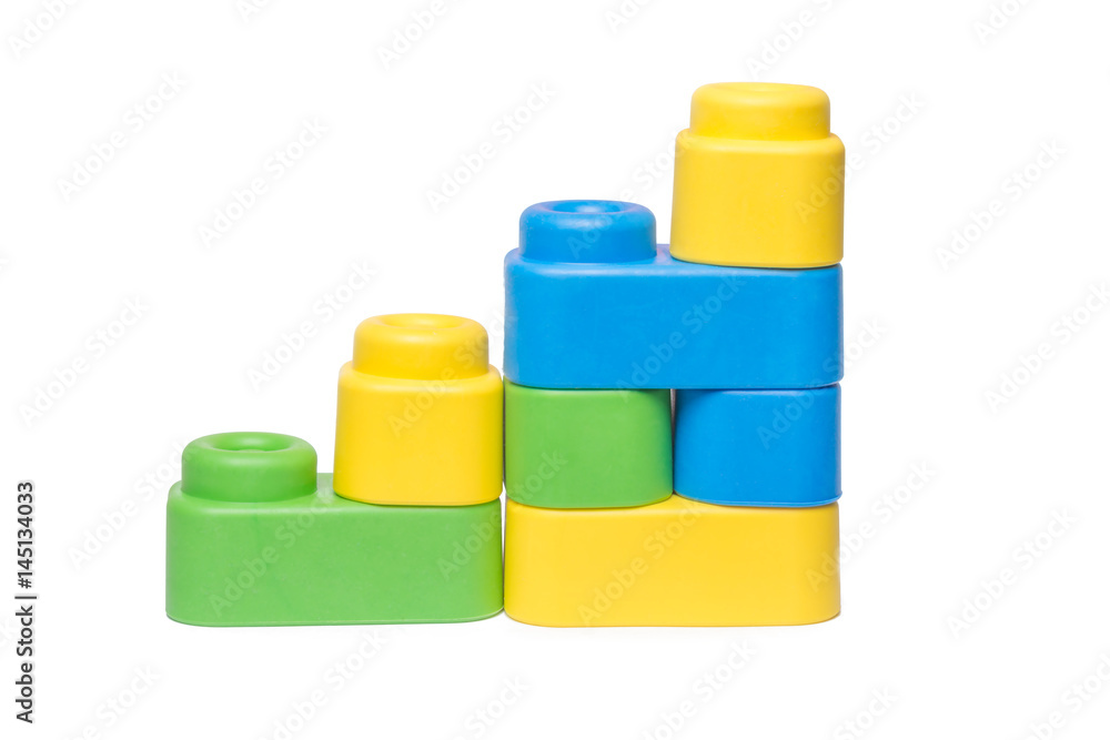 Toddlers hand playing with large toy bricks Toddlers hand playing with large toy bricks