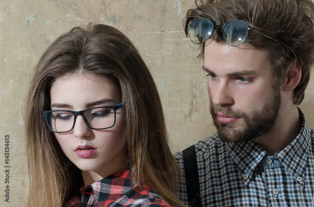 Obraz premium Young nerd couple of students in geek glasses