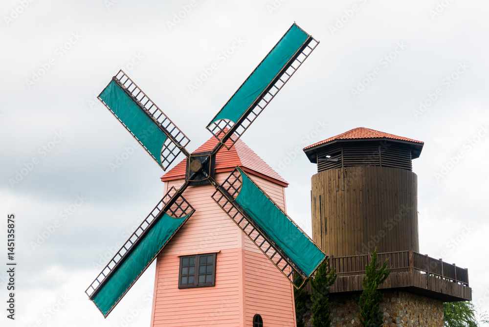 Pink lighthouse with green wind turbine Pink lighthouse with green wind turbine