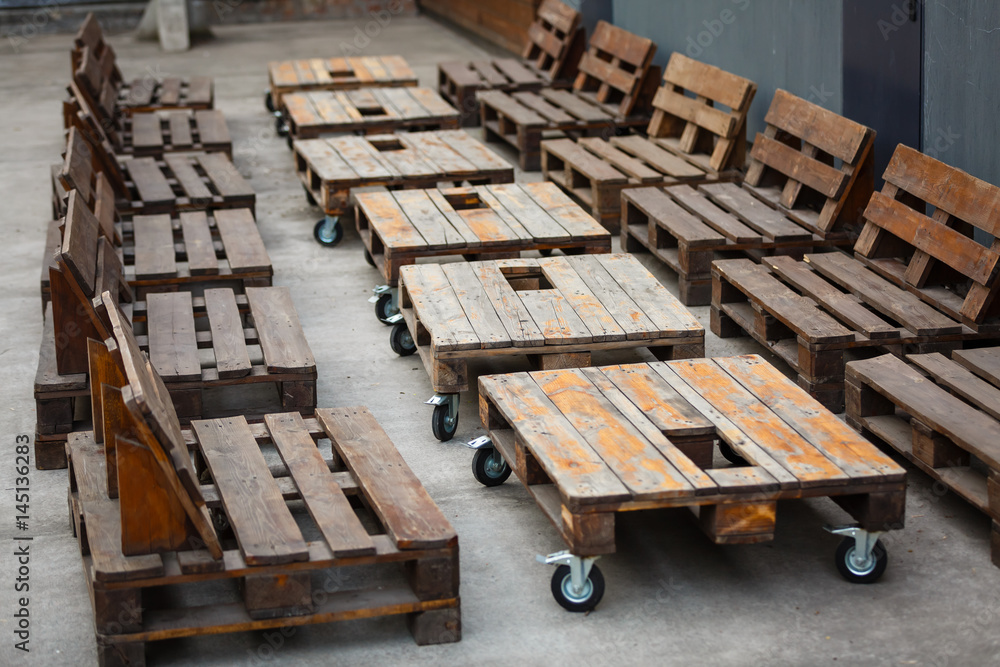 Wedding. Banquet. Decor. chill out area made of wooden storage pallets and soft pillows Decor of wooden pallets Wedding. Banquet. Decor. chill out area made of wooden storage pallets and soft pillows Decor of wooden pallets