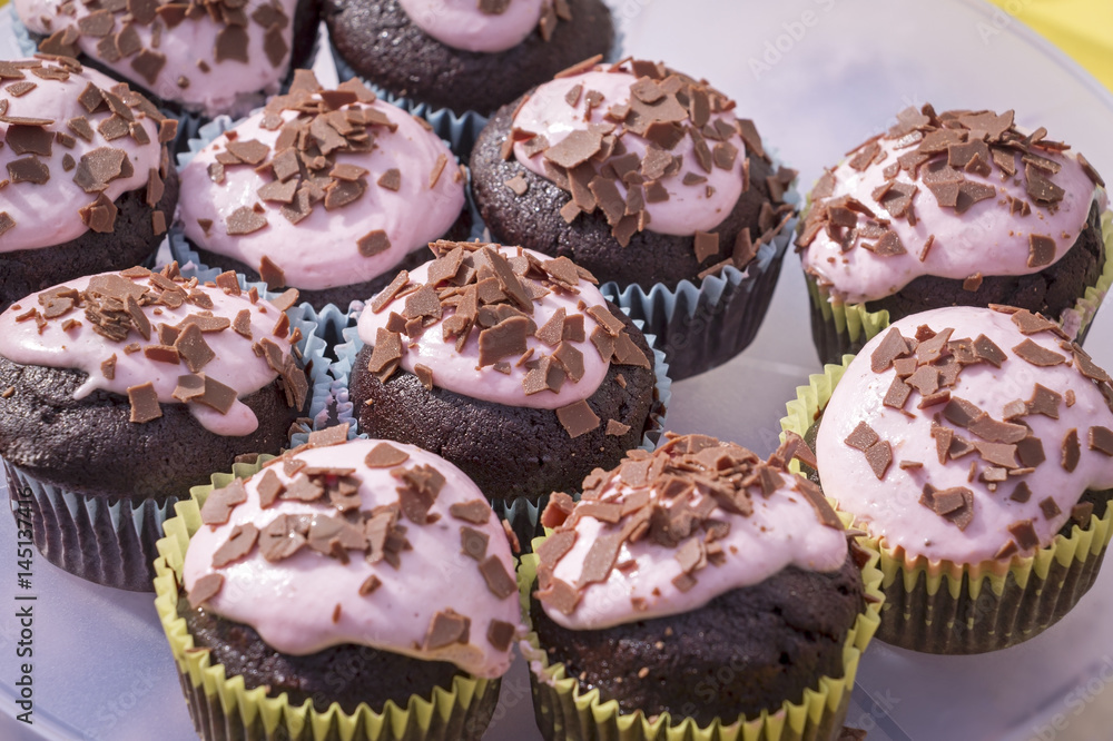Muffins stands on the table, garnished with strawberry cream Muffins stands on the table, garnished with strawberry cream