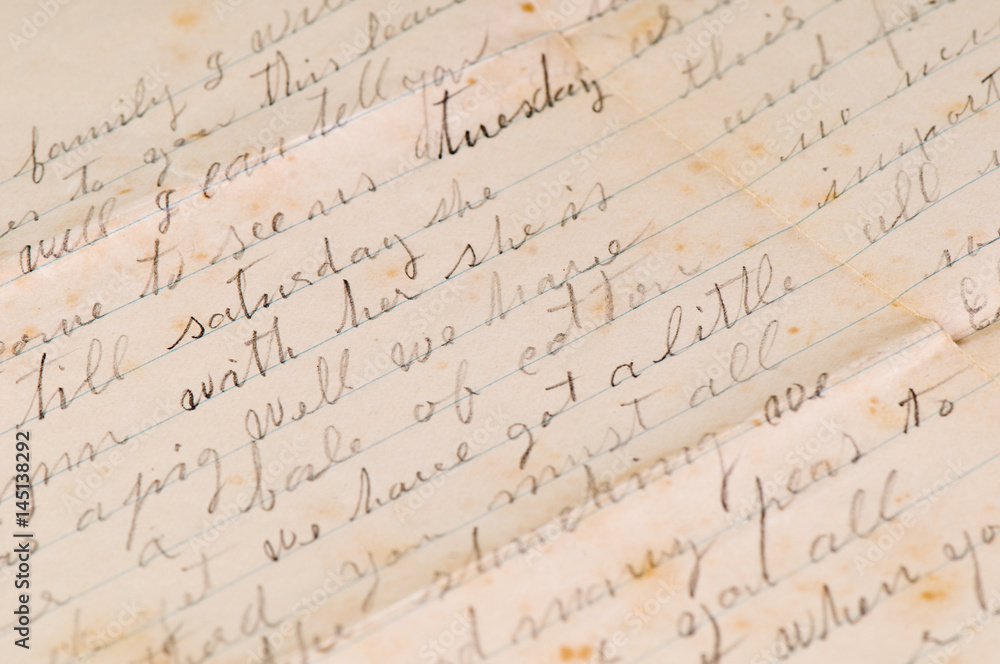 Vintage distressed aged handwritten letters with a shallow depth of field background