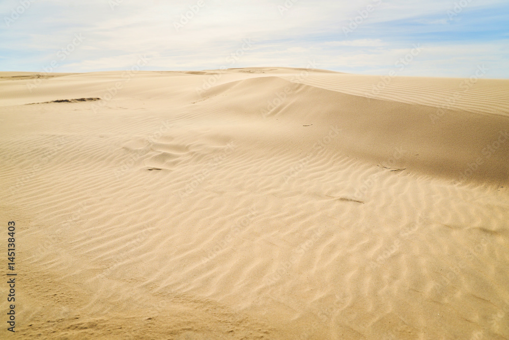 Moving colorful sand dunes in a sunny day