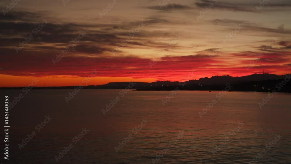 Silhouettes of mountains against the sky at sunset. Seascape . City lights by the sea. Sinai Peninsula. Egypt Silhouettes of mountains against the sky at sunset. Seascape . City lights by the sea. Sinai Peninsula. Egypt