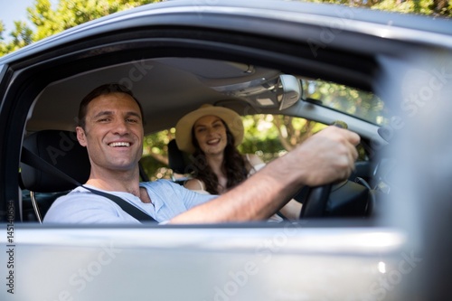 Cheerful couple sitting in car © wavebreak3