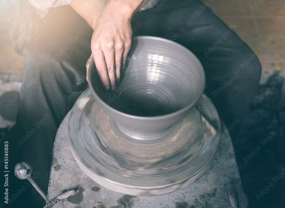 Potter making a clay pot, handmade, selective focus