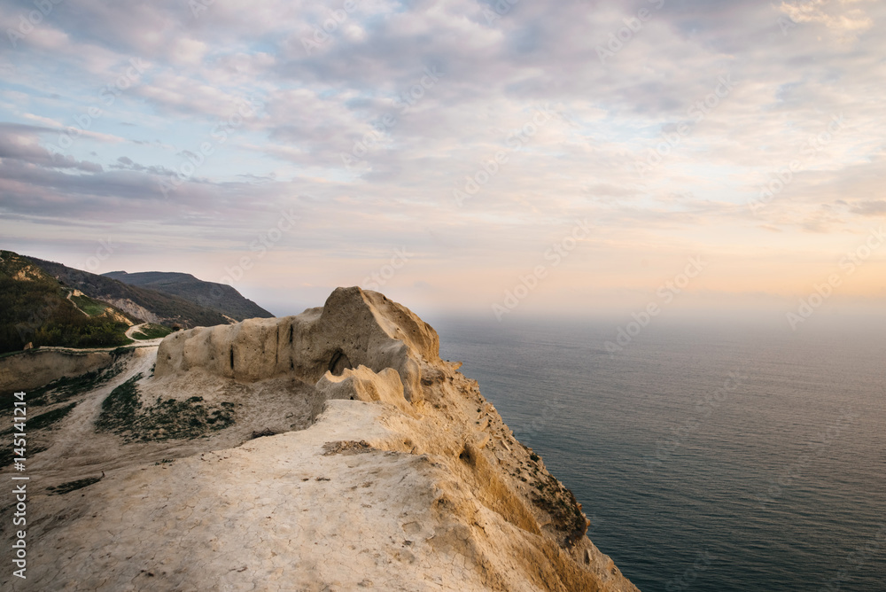 Fototapeta premium Sea and rock at the sunset. Nature composition.