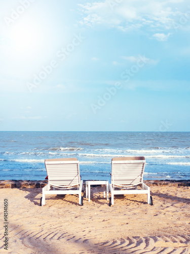 Obraz na płótnie Beach chairs on the sand beach with cloudy blue sky, Relax, vacation time w salonie