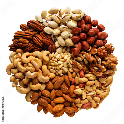 Assorted nuts in the form of a circle (peanuts, almonds, hazelnuts, pine nuts, cashews, walnuts, pistachio) isolated against the clear white background.