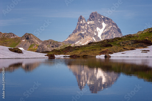 The Midi d'Ossau peak reflected in a lake in the Pyrenees National Park, Spain