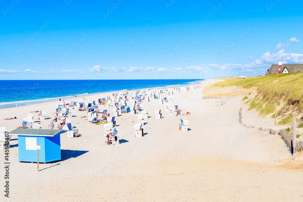 Wicker chairs on sandy beach in Kampen village, Sylt island, Germany Wicker chairs on sandy beach in Kampen village, Sylt island, Germany