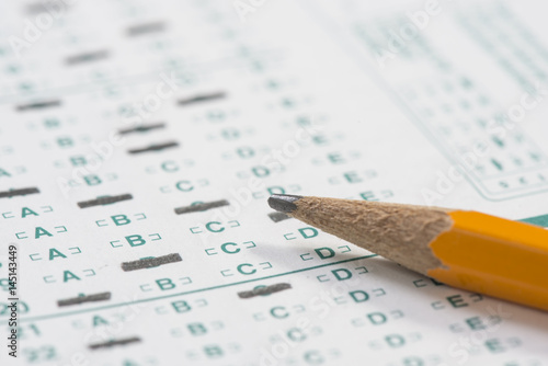 Close up of a standardized test form with a pencil resting on it with a shallow depth of field photo