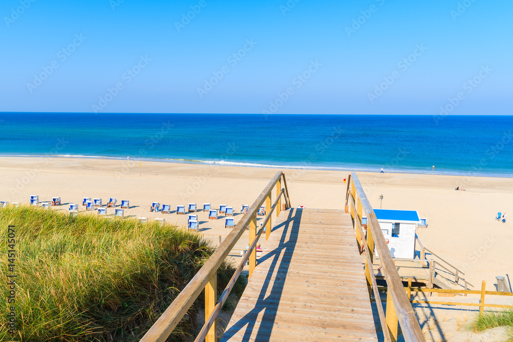 Wooden steps from sand dune to beautiful Westeland beach, Sylt island, Germany