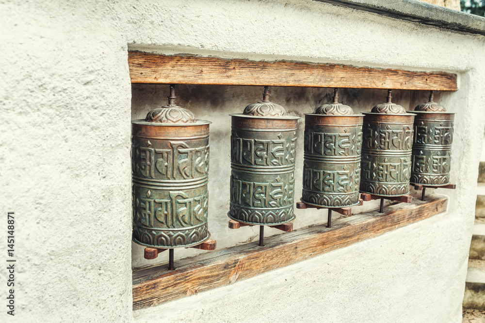 The row of authentic buddhist prayer drums The row of authentic buddhist prayer drums