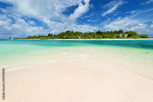 Beautiful white sand tropical beach with palm trees. Copy space.