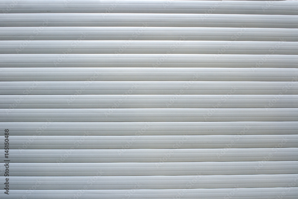 Background: closed white shutters in store window Background: closed white shutters in store window