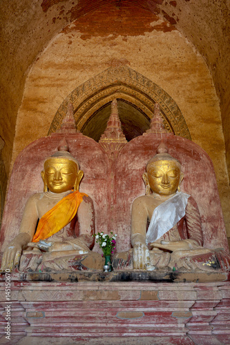 Two old Buddha statues sitting in meditation in Dhammayangyi pagoda in Bagan, Myanmar.