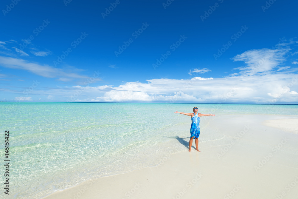 Happy standing woman arms outstretched on the white sand beach.Copy space Happy standing woman arms outstretched on the white sand beach.Copy space