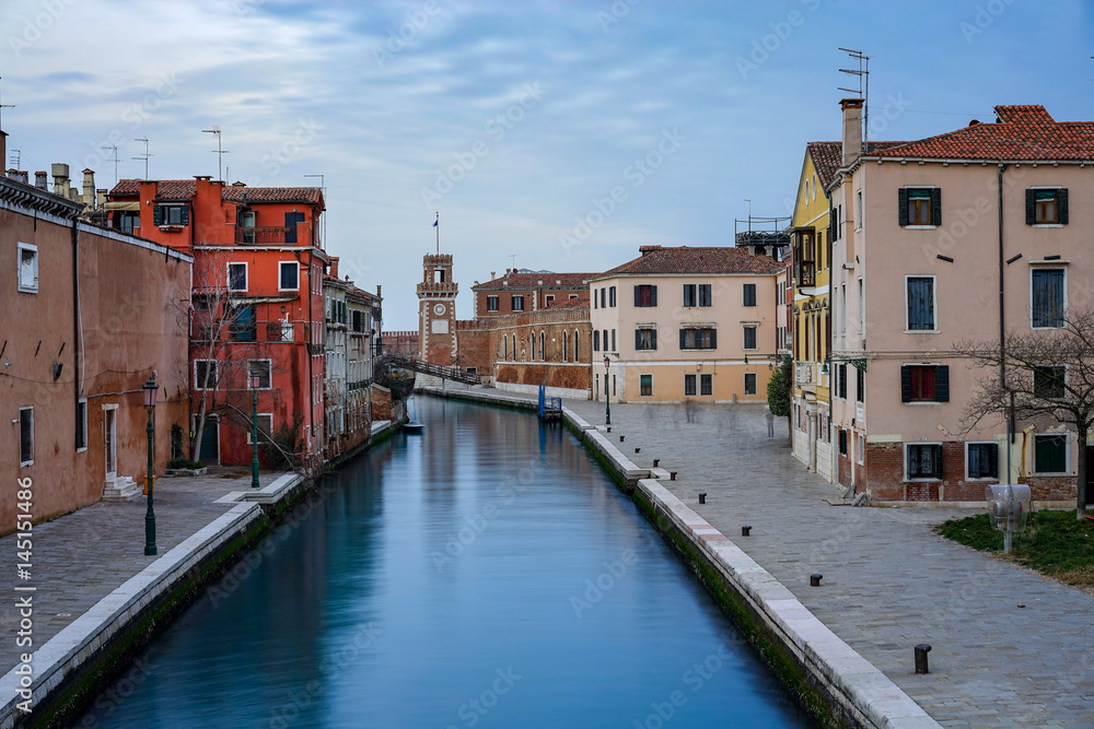 One of the canals in Venice and the Arsenal Tower in the distance. Italy, blue hour
