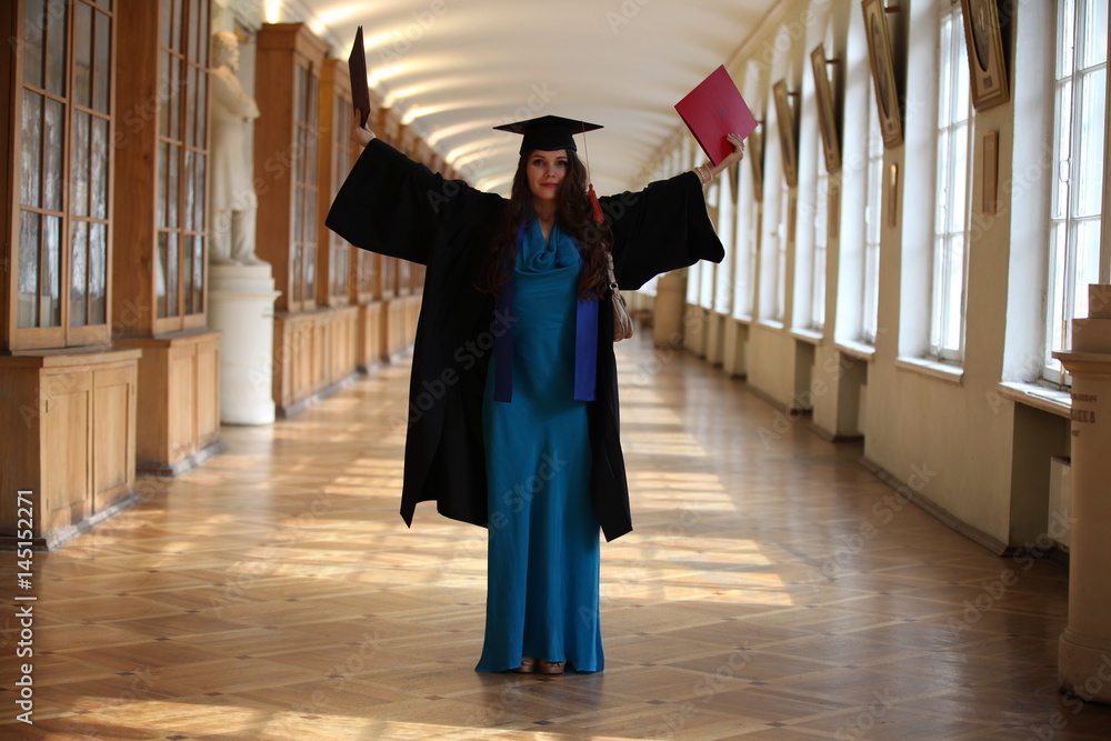 Beautiful College graduate in gown with diploma