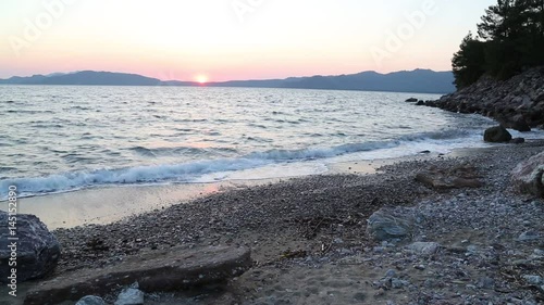 Beuatiful waves of mediterranean sea during sunset near hisaronu, marmaris photo