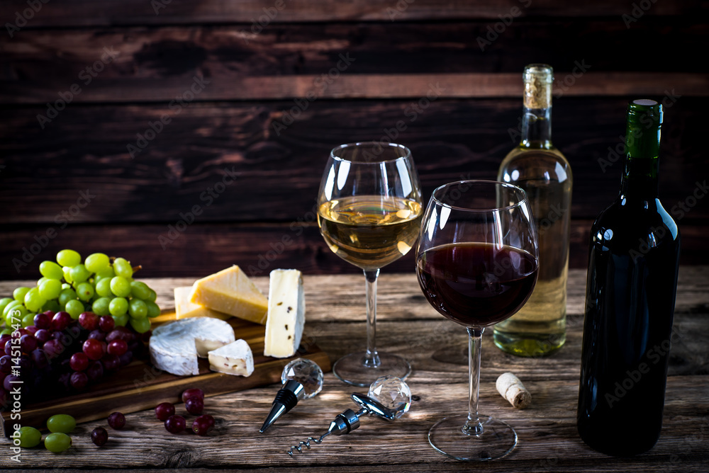  Wine bottles with grapes and cheese on wooden rustic background. copy space
