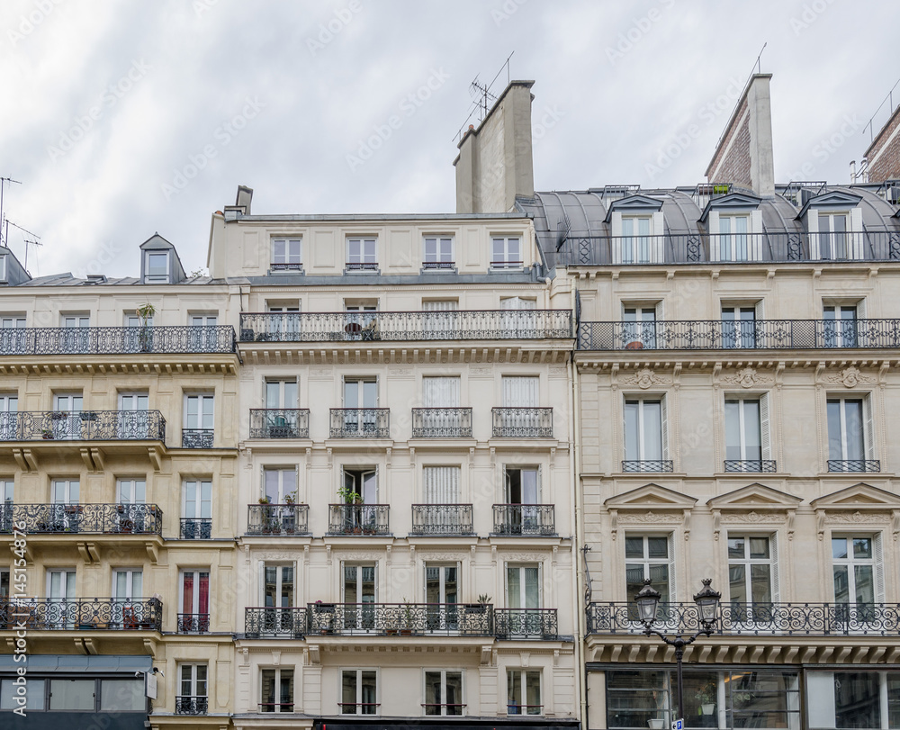 Generic Paris buildings with typical parisian attics and dormer windows and beautiful balconeys in this beautiful european city