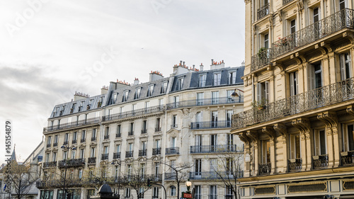 Typical street view from paris with beautiful classic buildings in this wonderful european destination on a bright sunset