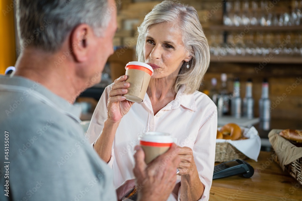 Senior couple interacting with each other while having coffee Senior couple interacting with each other while having coffee