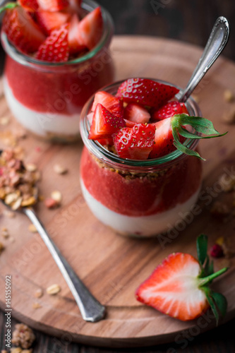 Wallpaper Mural Delicious homemade granola, yogurt and strawberry parfait in glass jars on rustic wooden background Torontodigital.ca