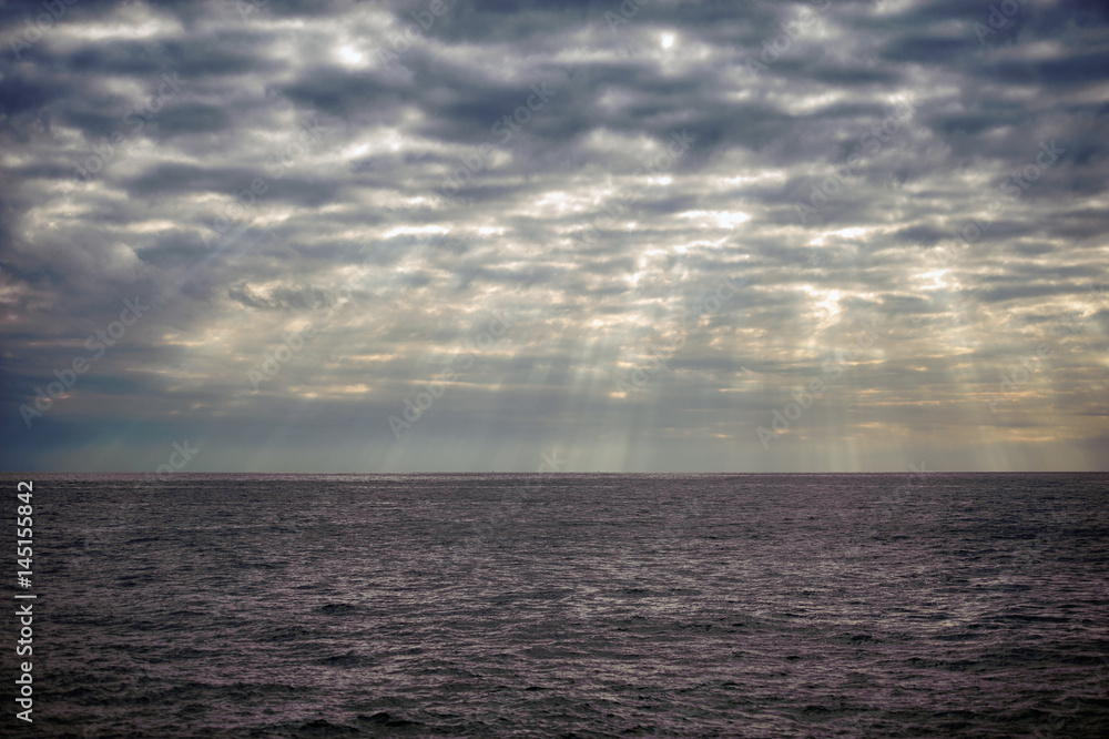 Stormy sky with sun rays on Mediterranean sea in Italy Stormy sky with sun rays on Mediterranean sea in Italy