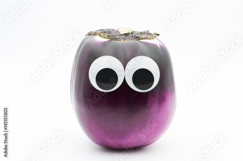 eggplant with googly eyes on white background