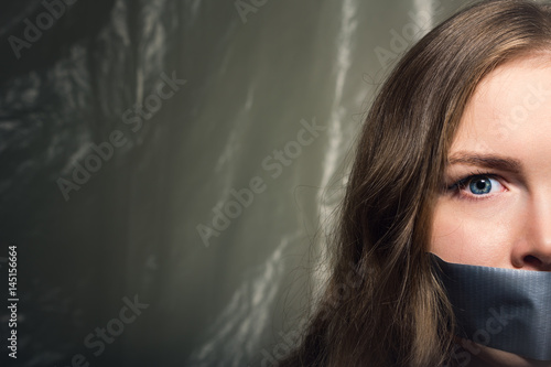 Photos A beautiful girl with a gag in her mouth as a symbol of censorship
