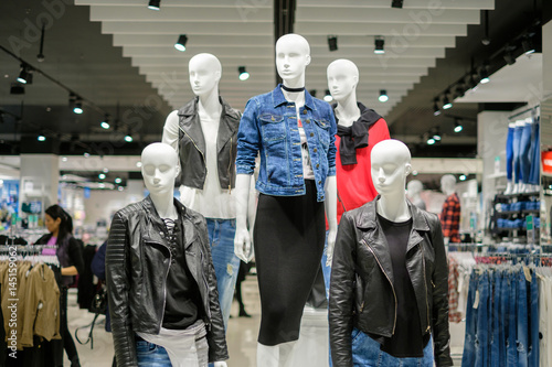 Set of woman mannequins in modern leather and jeans jackets, vest in clothes store