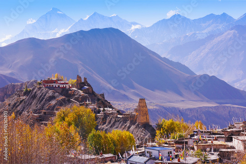 Jhong local village with old buddhist monastery at Muktinath valley with Dhaulagiri mountain summit on the background, horizontal view, Nepal, Annapurna Circuit; Himalaya; Asia photo
