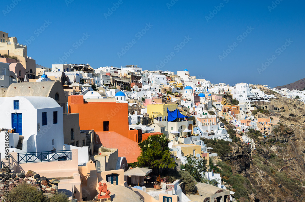 Traditional white architecture with blue churches on Santorini island, Greece Traditional white architecture with blue churches on Santorini island, Greece