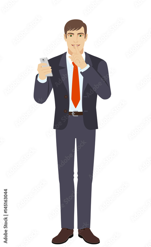 Businessman holding mobile phone and showing hush-hush sign Businessman holding mobile phone and showing hush-hush sign