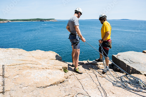 Two climbers looking over rock's edge