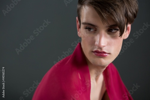 Thoughtful androgynous man wrapped 