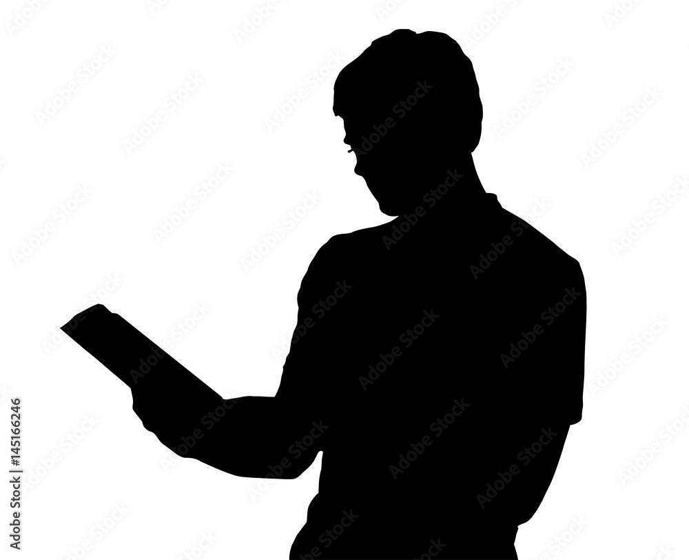 Profile portrait silhouette of standing teenage boy reading book