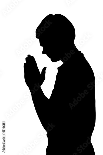 Side profile portrait silhouette of religious teenage boy praying