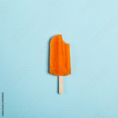 Tasty and refreshing popsicles on blue background