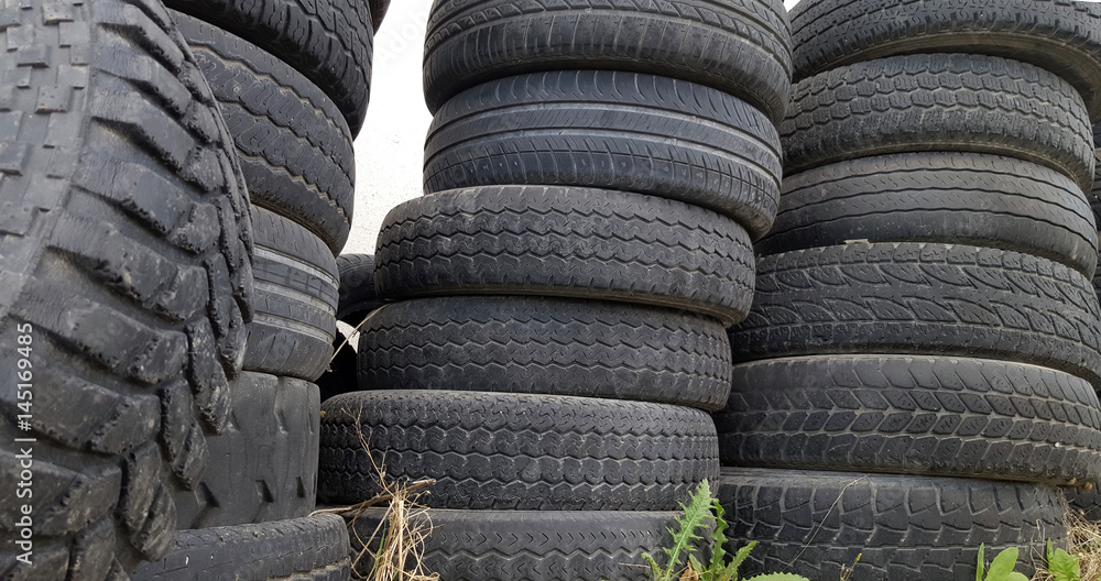 Stack of old and worn automobile tires Stack of old and worn automobile tires